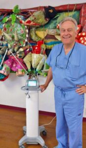 Photo of Dr. Gjebre and his brand-new LightScalpel CO2 laser.